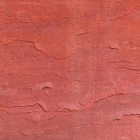 Fondo de textura de piedra rugosa roja. foto