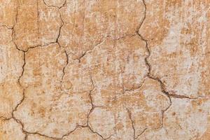 Brown adobe clay wall texture background. photo