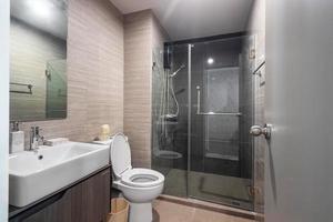 White Modern and Wood Bathroom with Shower Cabin Glass in Apartment photo