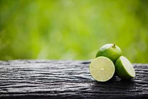 Green lemon sliced on wood photo