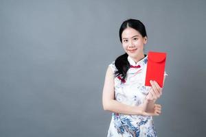 Asian woman wear Chinese traditional dress with red packet photo