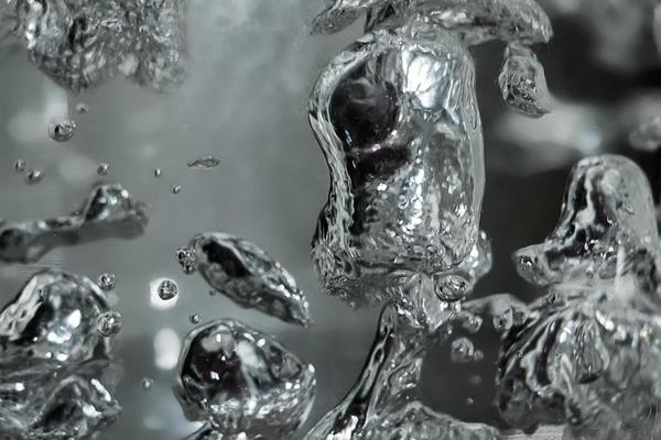Drops and bubbles of mercury in water. Dangerous chemical element