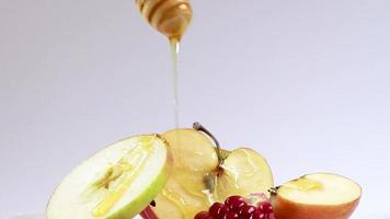 Sweet honey dripping on apples and pomegranates. Happy Rosh Hashanah. video