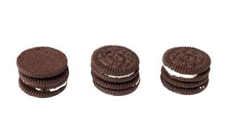 Tasty chocolate cookies with cream on white background photo