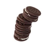 Tasty chocolate cookies with cream on white background photo