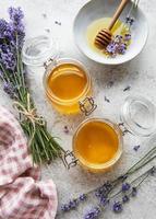 Jars with honey and fresh lavender flowers
