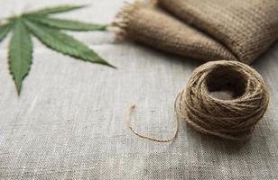 Cannabis leaves on the hemp textile background photo