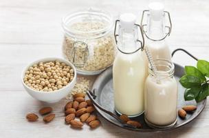 Alternative types of vegan milks in glass bottles photo