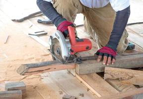 Man carpenter cutting wood photo