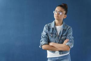 Upset teenage girl in glasses with her hair pulled up photo