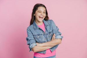 Girl crossed her arms over her chest, looked at the camera and winked photo