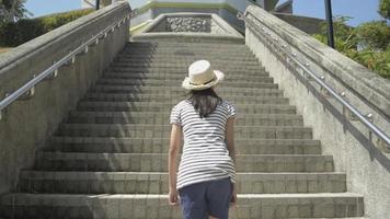 Girl Wearing Straw Hat Walking up On Staircase to The View Point Tower video