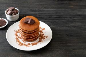 Chocolate pancake stack with chocolate powder photo