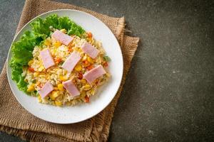 Homemade fried rice with ham and mixed vegetables of carrots, and green bean peas photo