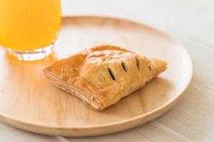 Pie on wood plate with orange juice photo