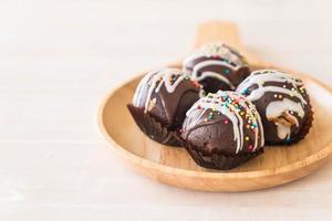 Fancy chocolate ball on wood plate photo