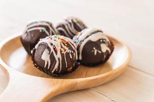 Fancy chocolate ball on wood plate photo