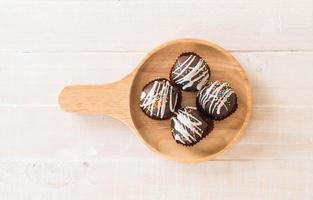 Fancy chocolate ball on wood plate photo