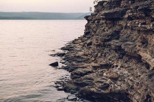 Texture of a rocky shore near the water. Rock pile background photo