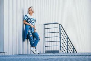 Beautiful girl with short white hair dressed in jeans in urban style photo