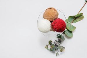 Bowl of colorful ice cream balls on white background photo