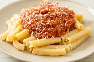 Rigatoni pasta with pork bolognese sauce - Italian food style photo