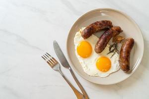 Homemade double fried egg with fried pork sausage - for breakfast photo