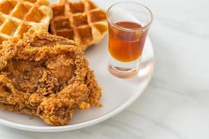 Homemade fried chicken waffle with honey or maple syrup photo