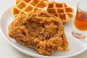 Homemade fried chicken waffle with honey or maple syrup photo