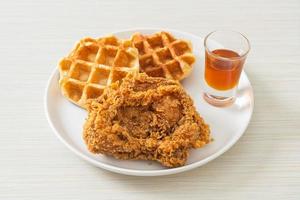 Homemade fried chicken waffle with honey or maple syrup photo