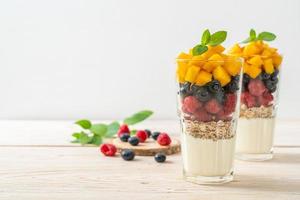 Homemade mango, raspberry and blueberry with yogurt and granola - healthy food style photo