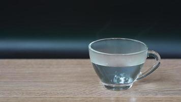 slow motion of steam from  hot water in glass served on table video