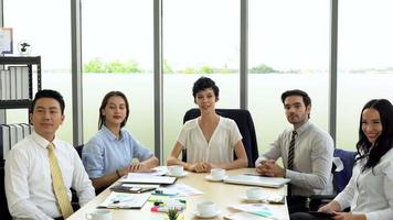 multiethnic team talking with client in meeting via video conference