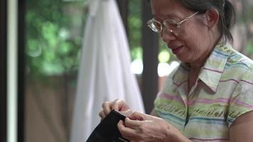 senior woman embroidering at home video