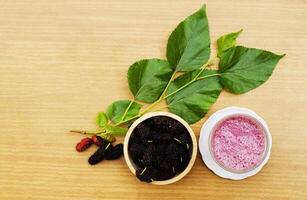 Homemade mulberry juice drink on wood backgrounds above photo