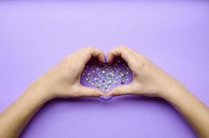 Girl holding hands with heart. Stylish trendy photo