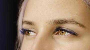 The lashes are black with splashes of blue. photo