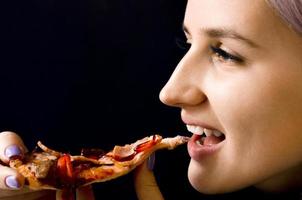 Girl eating pizza. Not healthy food. Home delivery. photo