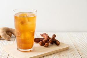 Delicious sweet drink tamarind juice and ice cube photo