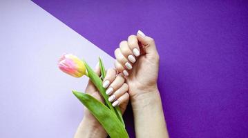 Female manicure on a bright background. Purple photo