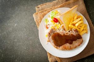 Pork steak with black peppers gravy sauce and mini salad photo