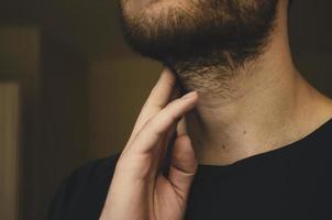 A young man checks his pulse. Close up. photo