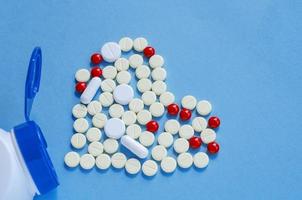 White heart pills on a colored background. photo