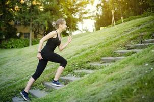 The girl runs up the stairs. Healthy lifestyle. photo