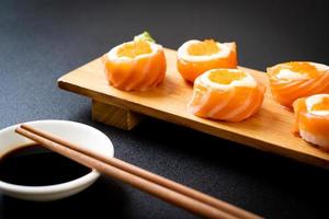 Fresh salmon sushi roll with mayonnaise and shrimp egg - Japanese food style photo