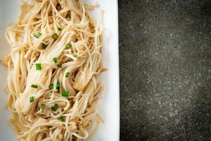 Stir-fried golden needle mushroom with butter on white plate photo