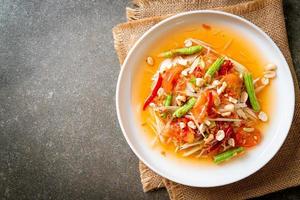 Papaya spicy salad - Som Tam - Thai traditional street food style photo