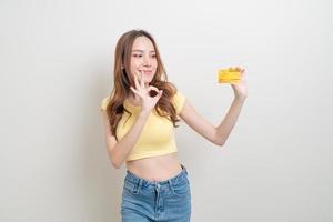 Portrait beautiful Asian woman holding credit card on white background photo