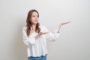 Portrait beautiful Asian woman with hand presenting or pointing on white background photo