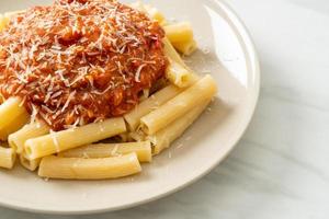 Rigatoni pasta with pork bolognese sauce - Italian food style photo